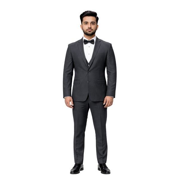Man wearing a gray suit with a bow tie on a white background